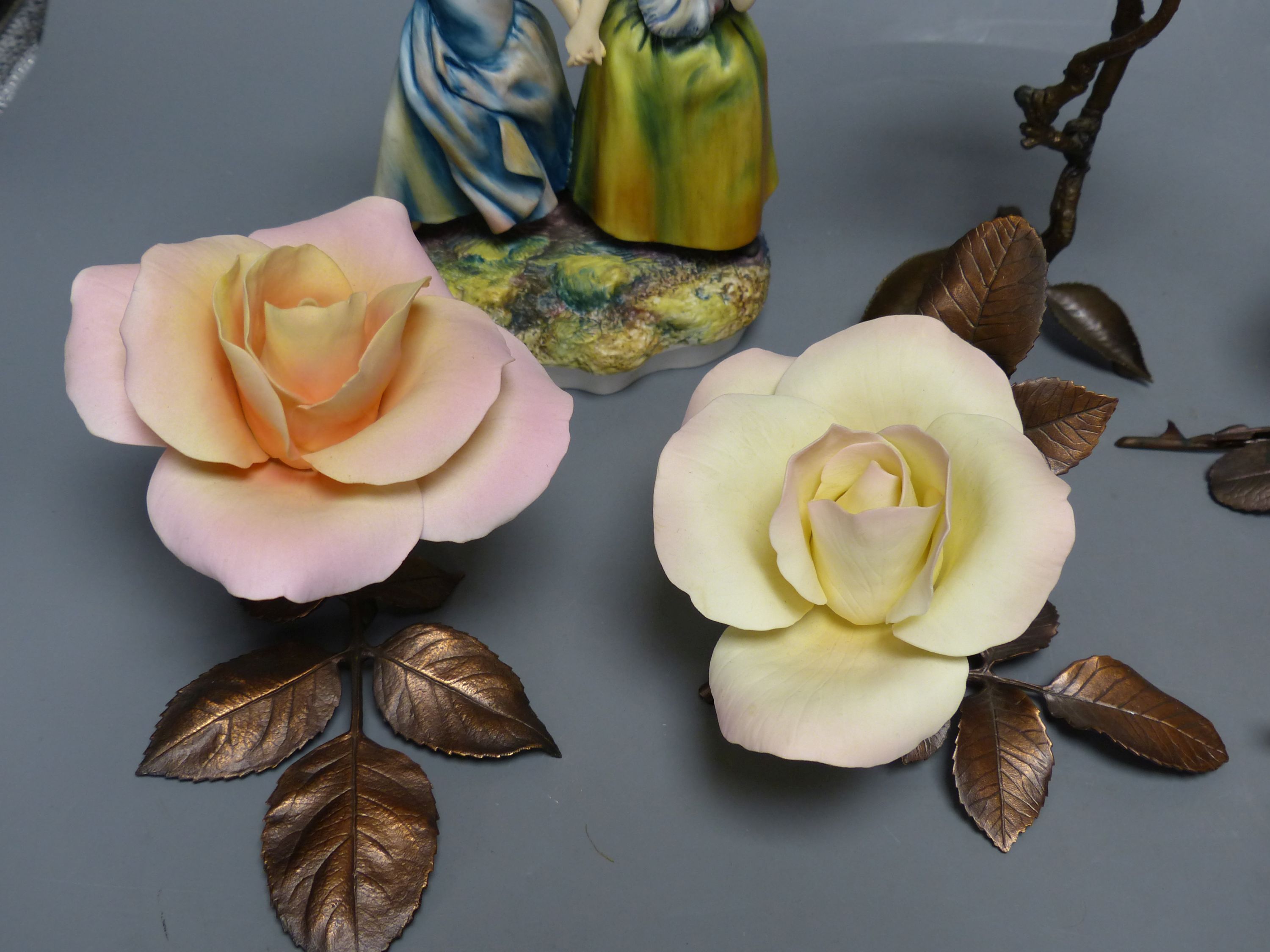 Four Boehm porcelain and bronzed metal roses, a similar model of a bullfinch eating berries and a Hereford Fine China group of two girls